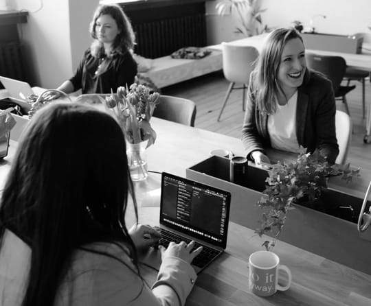 women working on their laptops